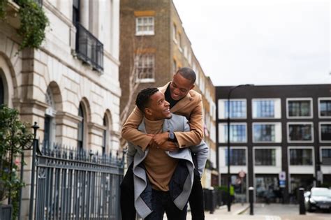 Free Photo Gay Couple Piggy Back Riding While Happily Out On A Date