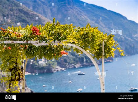 Red Bignonia Campsis Flower On Iron Arch On Amalfi Coast Stock Photo