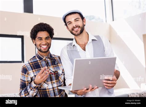 Portrait Of Smiling Gay Couple Using Laptop Stock Photo Alamy