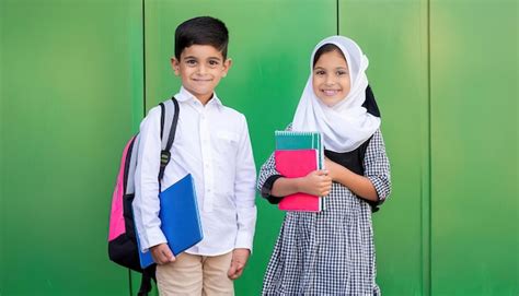 Happy Muslim School Kids Over Green Background Premium Ai Generated Image
