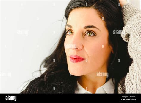 Portrait Of Mature Brunette Woman With Beautiful Eyes In Casual Pose And White Background