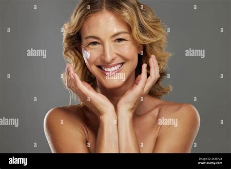 Skincare Beauty And Face Cream For Mature Woman With Anti Aging Product Against Grey Mockup