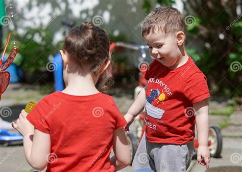 Brother And Sister Are Playing With Soap Bubbles Stock Image Image Of