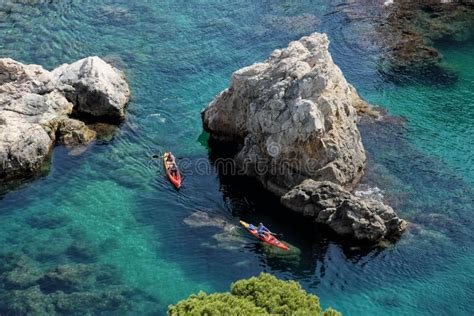 Two Boats Floating Through The Clear Blue Ocean Waters Of The Island