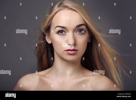 Beauty Headshot Of Sexy Woman With Bare Shoulders And Her Blonde Hair Blowing Stock Photo Alamy