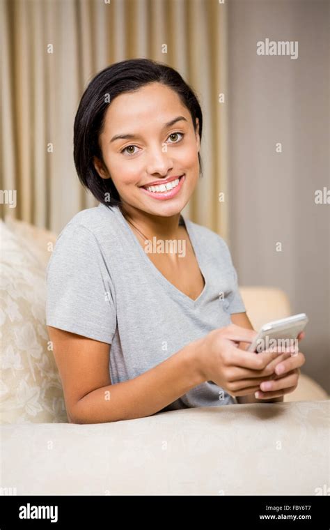 Smiling Brunette Using Smartphone Stock Photo Alamy