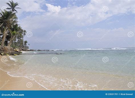 A Bright Sunny Day at the Beach Stock Image - Image of polhena, rocks ...