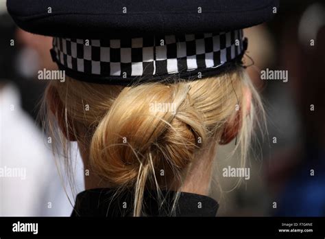 A Rear Photograph Of A Blonde Kent Police Woman And Here Hair Tied Up Behind Her And Tucked Into