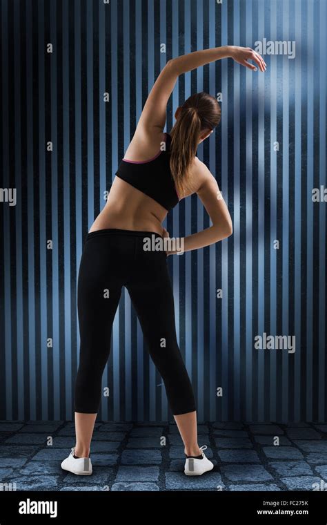 Composite Image Of Fit Brunette Stretching Rear View Stock Photo Alamy