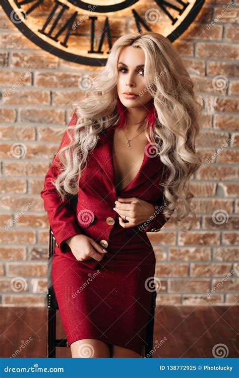 Alluring Blonde Woman In Red Suit Posing Against Clock Stock Image Image Of Season Model