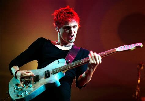 A Man With Red Hair Playing An Electric Guitar