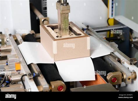 Innovative cardboard box former crafting precision designs in a modern manufacturing facility ...