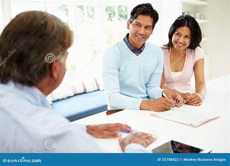 Indian Couple Meeting With Financial Advisor At Home Stock Photo