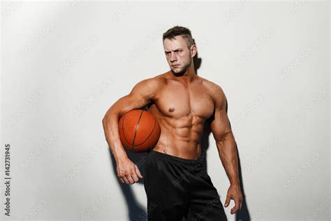 Very Muscular Naked Man Holding A Basketball In Studio Stock Photo Adobe Stock