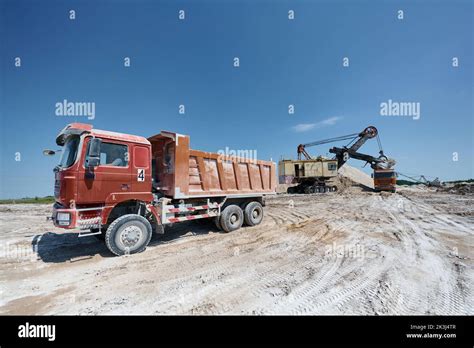 Red Tipper Truck Stands At Open Chalk Quarry At Summer Day Stock Photo