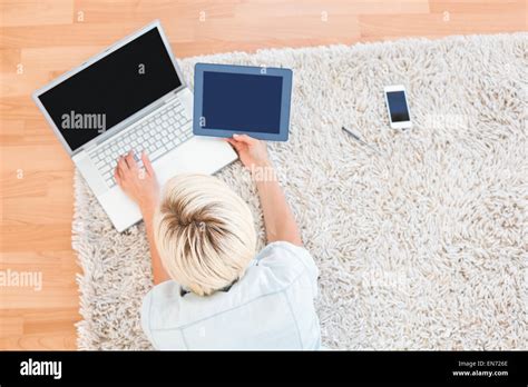 Pretty Blonde Woman Lying On The Floor While Using Her Laptop And Tablet Stock Photo Alamy