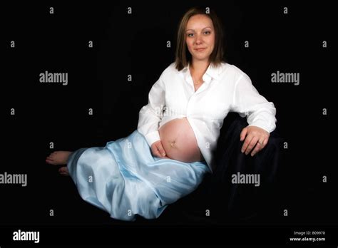 Pregnant Woman Sitting Touching Exposed Bare Naked Belly Tummy Stomach Stock Photo Alamy