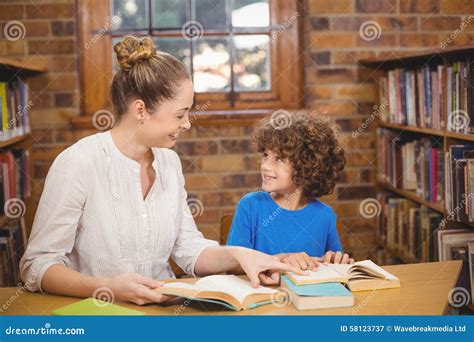 Blonde Teacher And Pupil Reading Books In The Library Stock Image Image Of Cheerful Knowledge