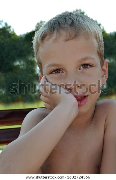 Half Naked Boy Sitting On Bench Stock Photo Edit Now