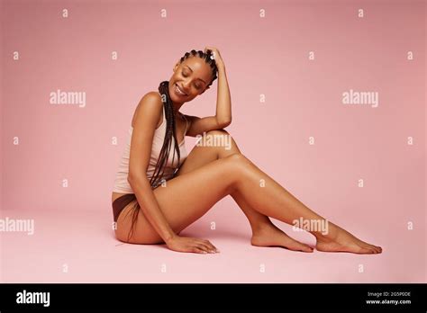 Beautiful Female Model Sitting On Pink Background African American Woman In Lingerie Smiling
