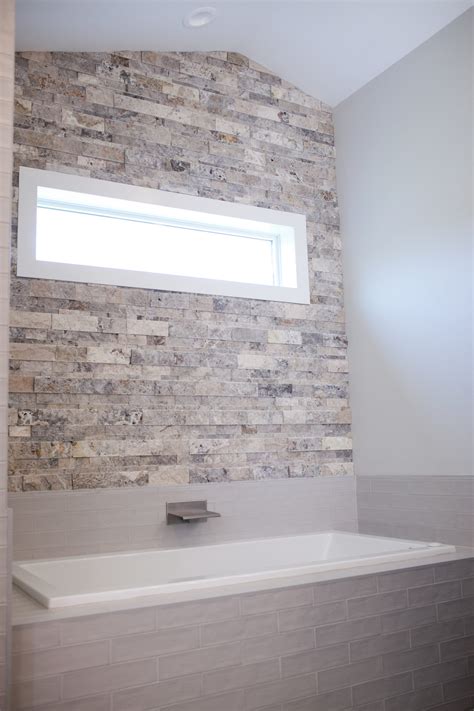 stacked stone accent wall with window - Pinnacle Homes, Inc.