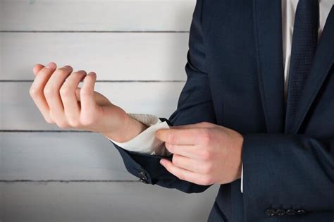 Premium Photo Businessman Adjusting His Cuffs On Shirt Against