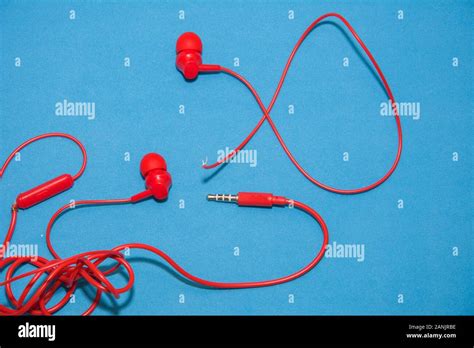 Red Broken Torn Headphones On Classic Blue Background Close Up Broken