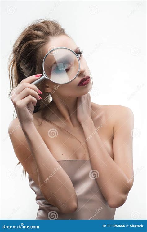 Beautiful Naked Shoulders Girl Looking Through A Magnifying Glass And Increases With It Her