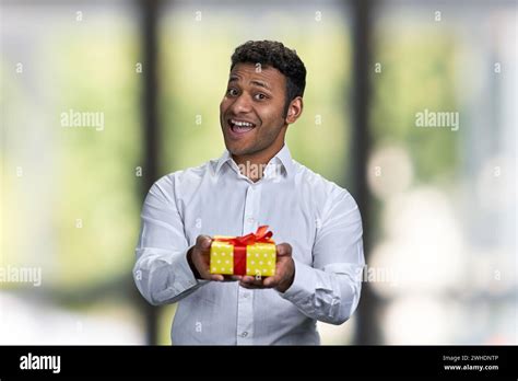 Happy Smiling Indian Man Handing T Box Abstract Blurred Background