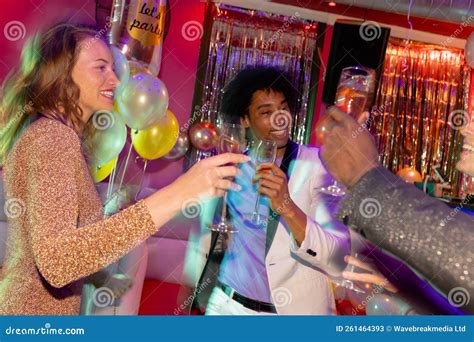 Three Happy Diverse Male And Female Friends Making A Toast With