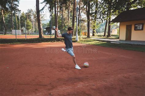 Black Haired Athlete Plays With A Balloon On A Clay Court Amateur Sport Individual Football