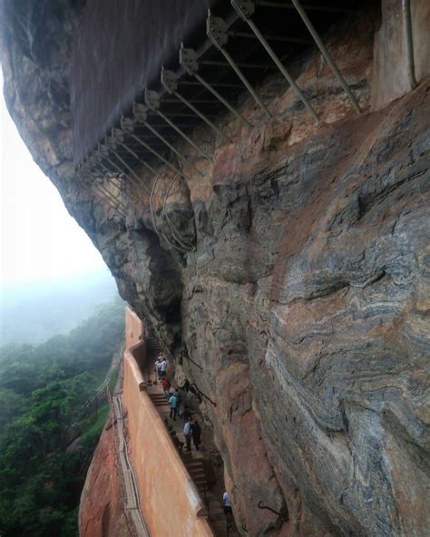 people climbing up the side of a cliff