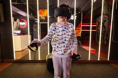 Boy Kid Playing Game Using Virtual Reality Headset And Gamepads In