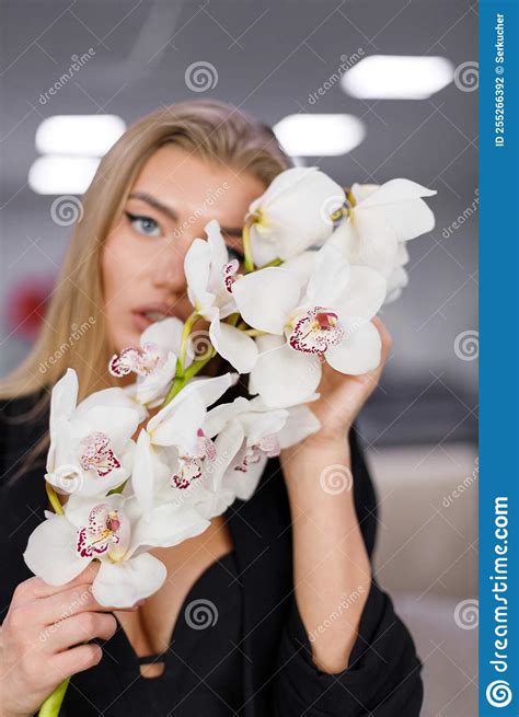 Portrait Of Seductive Blonde Woman With Orchid Branch In Her Hands Stock Photo Image Of
