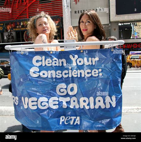 Two Naked Protesters Shower Behind A Banner That Reads Clean Your Conscience Go Vegetarian In