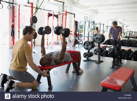 Personal Trainer Spotting Man Flat Dumbbell Chest Press Stock Photo Alamy