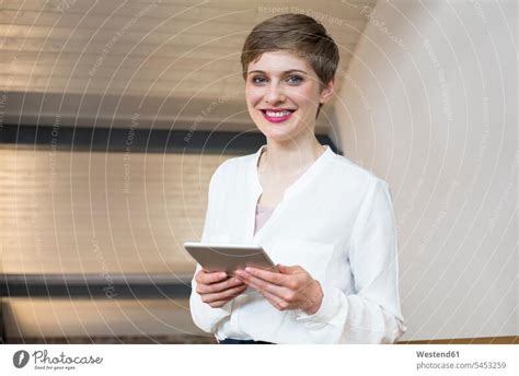 Portrait Of Smiling Businesswoman Using Tablet In Office A Royalty