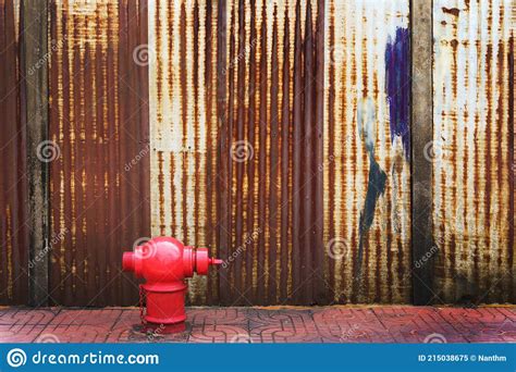 Red Fire Hydrant With Rusty Corrugated Iron Metal Fence Zinc Wall