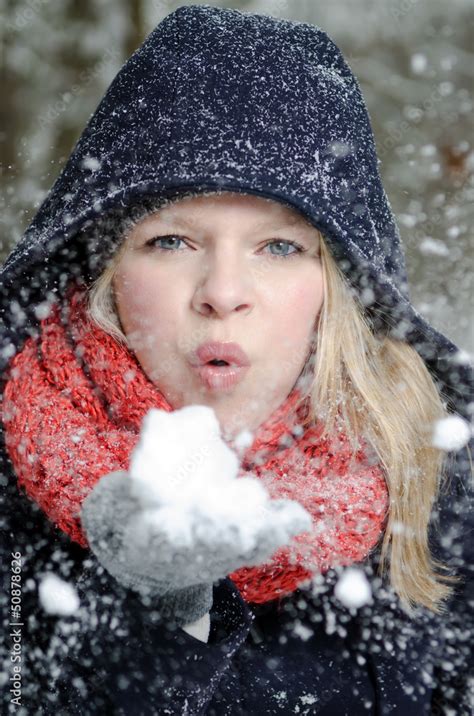 Junge Blonde Frau Pustet In Einen Handvoll Schnee Stock Foto Adobe Stock
