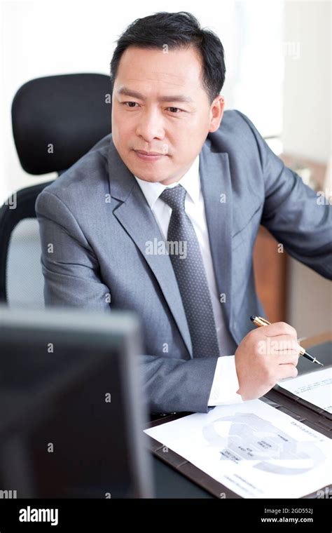 Mature Businessman Using Computer At Desk Stock Photo Alamy