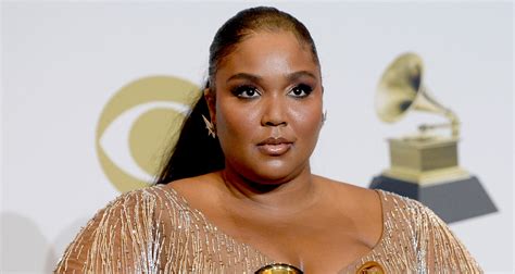 Lizzo Dazzles In Silver While Posing With Her Grammy Awards 2020