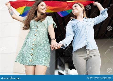 Lesbian Partners Holding Hands With A Gay Flag Stock Image Image Of Partner Couple