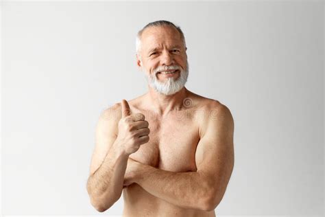 Portrait Of Mature Handsome Bearded Man Posing Shirtless Smiling Holding Glass Of Water