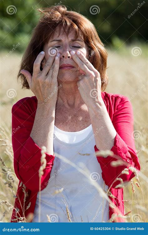 S Brunette Woman Massaging Face To Soothe Sinus Pain Outdoors Stock Photo Image Of Hair