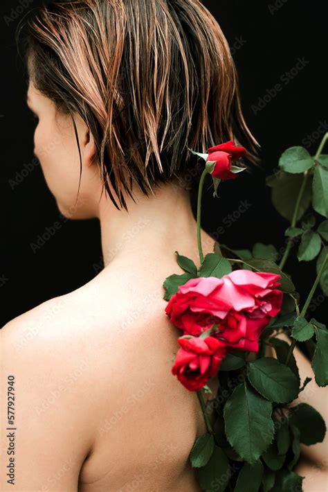 Naked Woman With Red Roses On Her Back Against Black Background Stock Photo Adobe Stock
