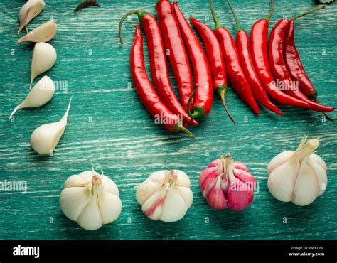 Red Hot Chili Peppers With Spice Ingredients Over Wooden Background