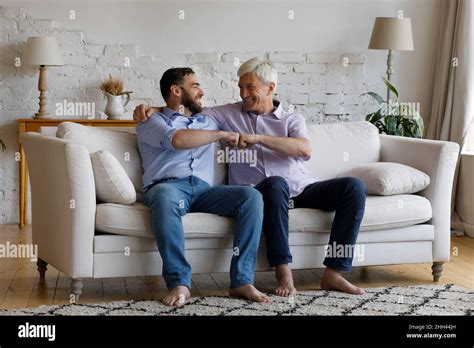 Happy Mature Grey Haired Dad Congratulating Adult Son On Success Stock Photo Alamy