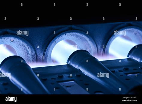 Closeup Shot Of Home Furnace Burner Ignited With Crimson Blue Flame