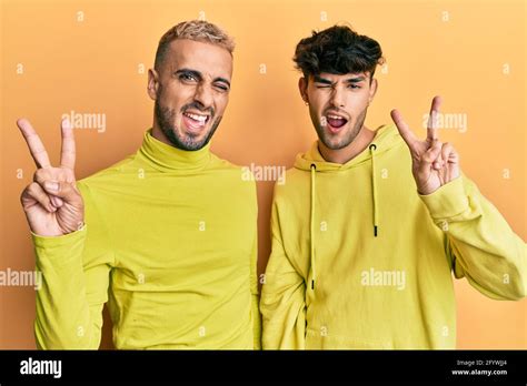 Homosexual Gay Couple Standing Together Wearing Yellow Clothes Smiling