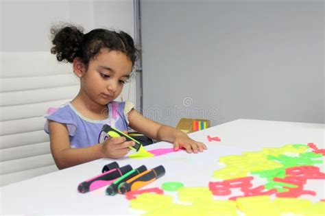 3 Year Old Latina Brunette Girl With Curly Hair Draws As Therapy For Autism And Attention